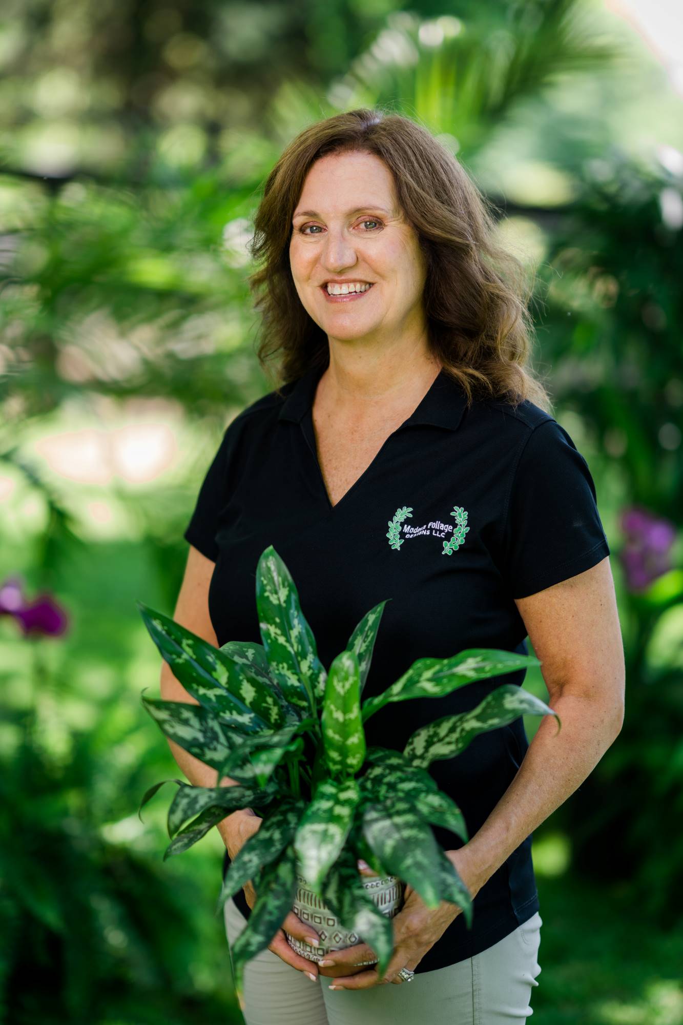 Photo of Gretchen holding a medium sized flower pot